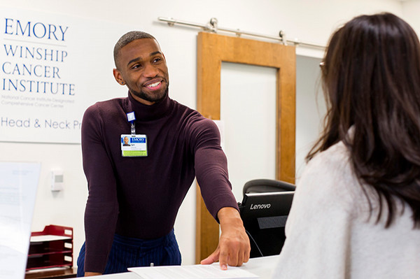 Clinic staff person sharing information with a visitor