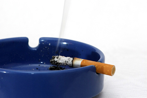 Lit cigarette in an ashtray (stock image)