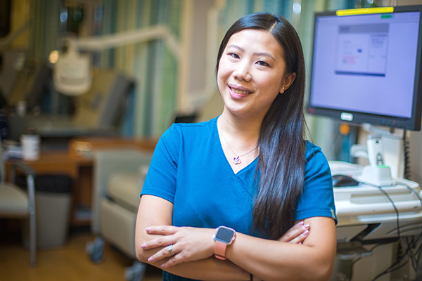 Oncology nurse standing in front of monitor