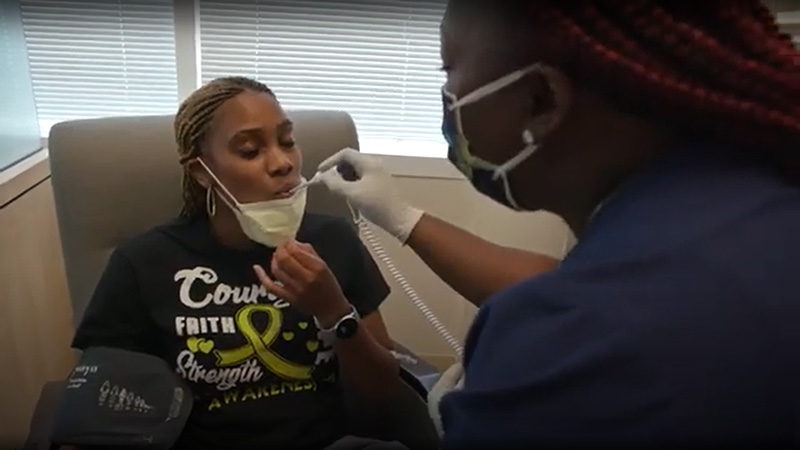 Oncology nurse taking a patient's temperature