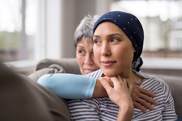 Mother embraces her adult daughter who is facing cancer (stock image)