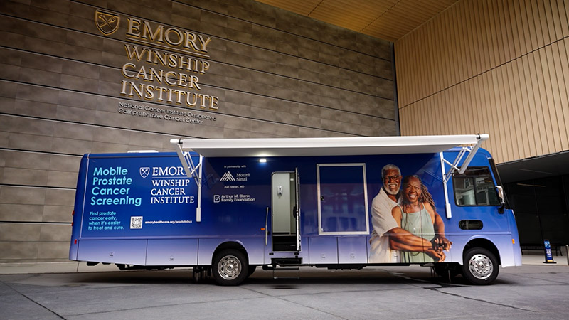 Winship's mobile prostate cancer screening bus parked in the entrance area of Winship at Emory Midtown.