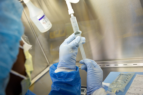 Pharmacy technician preparing study medication