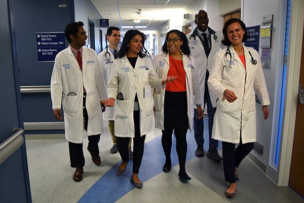 Emory hematology and medical oncology fellows walking together down a hallway