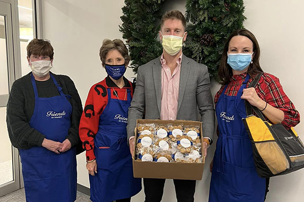 Friends of Winship volunteers distribute cookies during the holidays