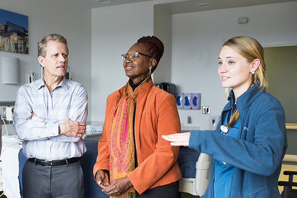 Winship patient and family advocates tour a new clinical space with a nurse.