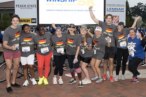 Leukemia survivor Kimi celebrates with her team at the Winship 5K