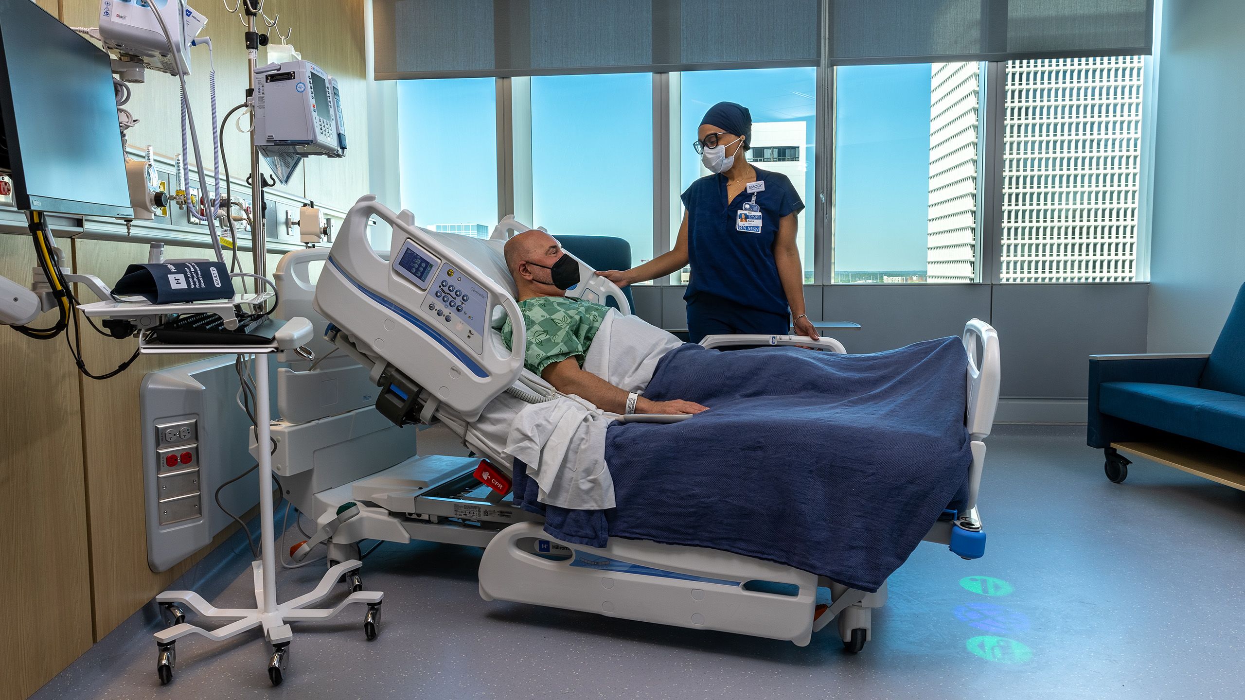 Inpatient room with patient and nurse