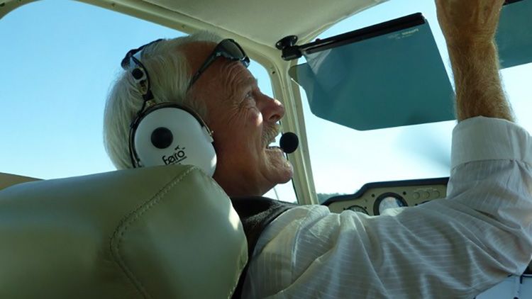 Keith in pilot seat preparing to take off with an aircraft