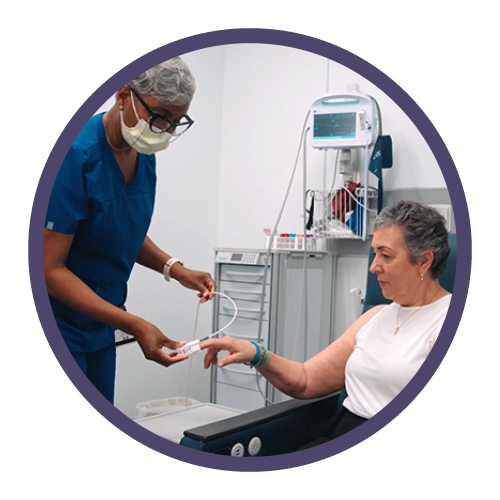 a photo of a nursing putting an IV into a female patient