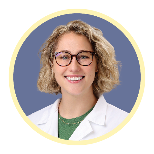 a portrait of a young female doctor with short blond hair and glasses smiling at the camera.