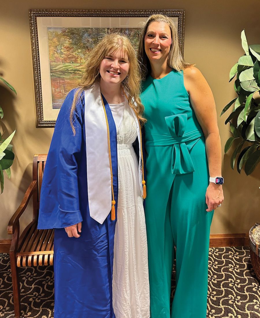 a photography of a mother and daughter attending daughter's high school graduation ceremony.