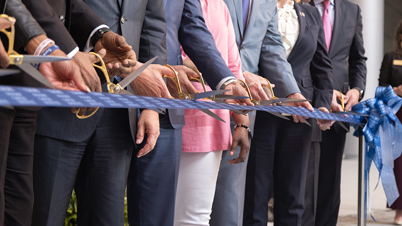 Winship, Emory and City of Atlanta leaders and special guests hold and cut ribbon during a special ceremony