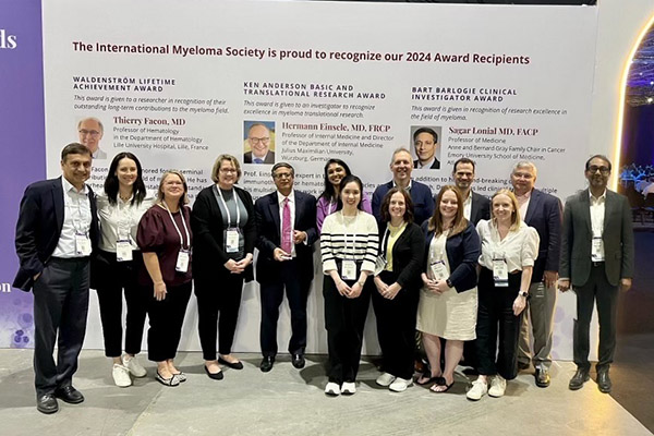 Winship attendees gather around Dr. Sagar Lonial with his award at the International Myeloma Society's annual meeting.