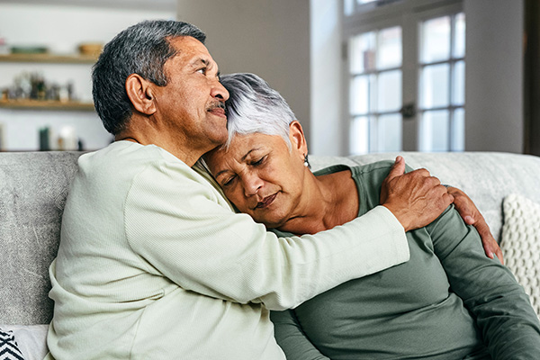 Middle aged man comforting spouse (stock image)