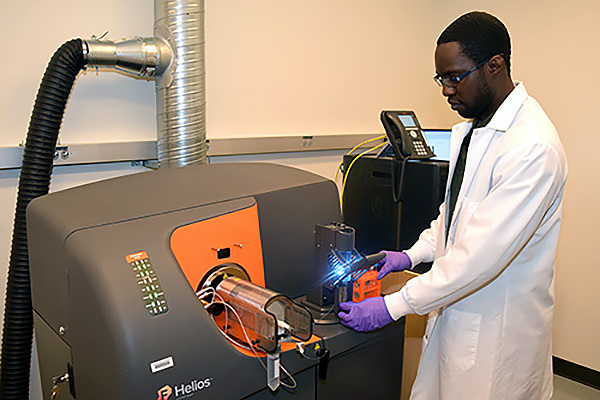 Lab technician operating the Helios mass cytometer