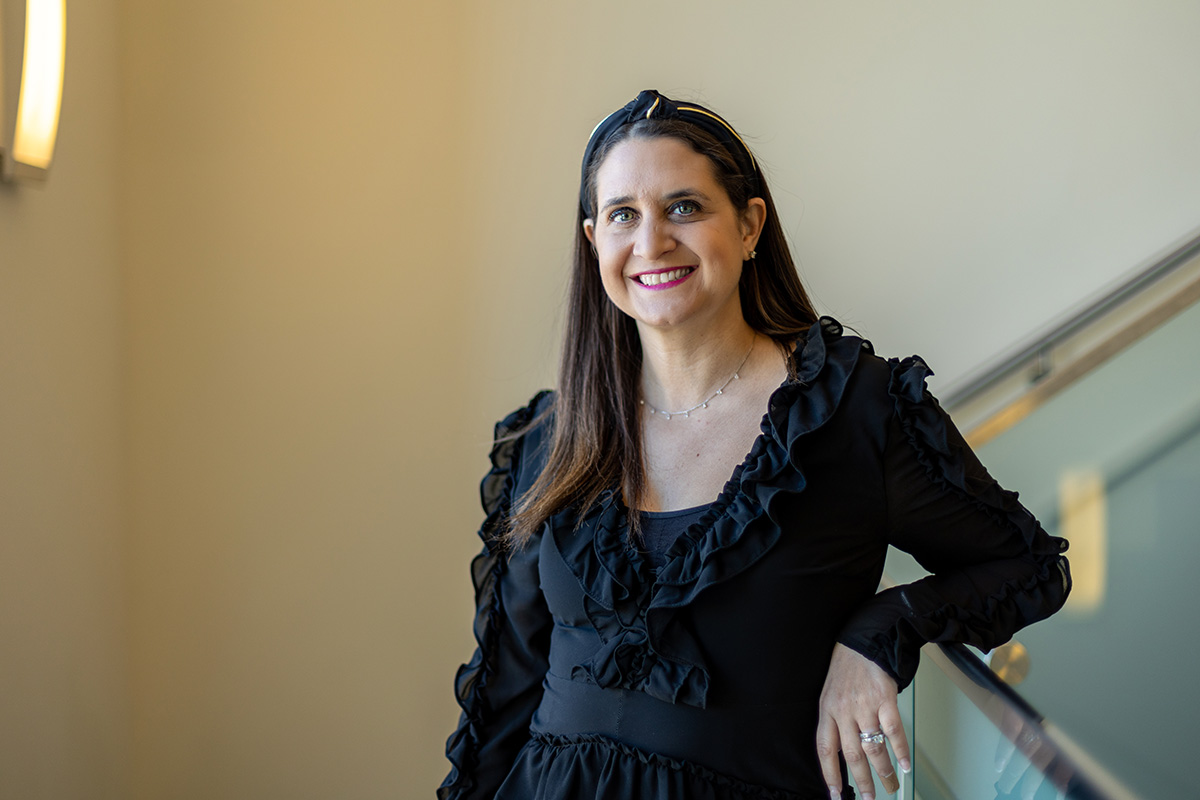 Alexandra smiling on a stairwell landing