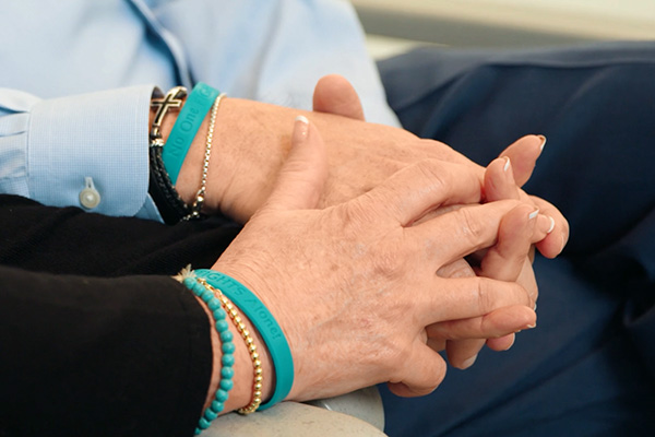 Two adults holding hands