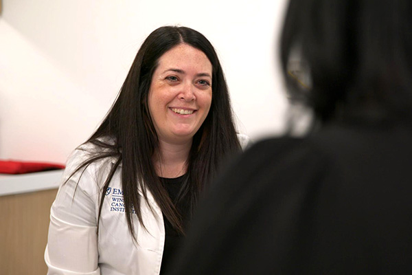 Speech language pathologist Lauren Ottenstein in exam room with patient