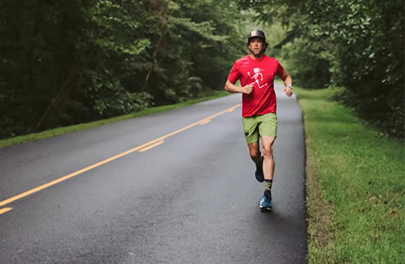 Ultra-runner Kenny running on a tree-lined road