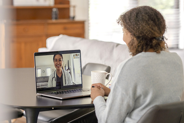 Adult woman having a telehealth session with a clinician (stock image)