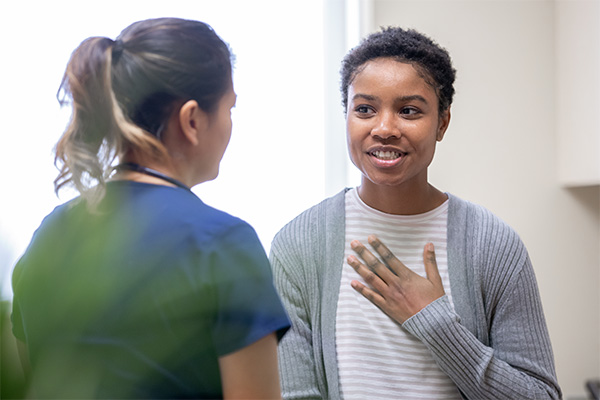 Young adult speaking with a nurse (stock image)